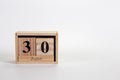 Wooden calendar June 30 on a white background