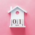 Wooden calender 1 april fool's day. Flat lay on pink background Royalty Free Stock Photo