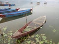 Wooden canoe boat of nepali people damage broken sunken ship in Phewa Tal or Fewa Freshwater Lake wait Nepalese wood carpenter or