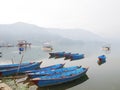 Wooden canoe boat of nepali people floating in Phewa Tal or Fewa Freshwater Lake wait service Nepalese people and foreign traveler Royalty Free Stock Photo