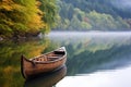 wooden canoe resting on bank of tranquil lake