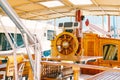 Wooden captains bridge on a white yacht with a beautiful steering wheel and folding tables