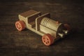 Wooden car with red wheels on the table. An old children`s toy. Royalty Free Stock Photo