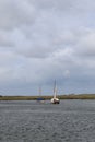 Sailing boats on the waters edge Brancaster east coast England at low tide