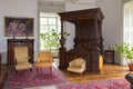 Wooden carved antique canopy bed with coat of arms.