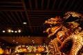 Wooden carving dragon under latticed ceiling in shop