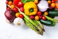 Wooden case with fresh ripe seasonal vegetables. Ingredients for cooking tasty light vegan meal. White background, close up, macro Royalty Free Stock Photo