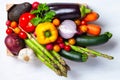 Wooden case with fresh ripe seasonal vegetables. Ingredients for cooking tasty light vegan meal. White background, close up, macro Royalty Free Stock Photo