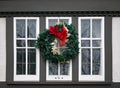 Wooden casement window decorated with Christmas wreath