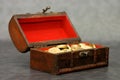 Wooden casket full of coins Royalty Free Stock Photo