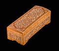 Wooden casket with traditional artistic carving isolated on a black background