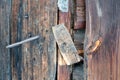 A wooden catch. A wooden gate valve on the door of the old barn.