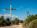 wooden catholic cross on top of a hill with rocks Royalty Free Stock Photo