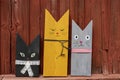 Wooden cats figures by the Red barn Wall