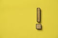 Wooden caution warning sign on yellow background for danger notification , error maintenance and exclamation concept Royalty Free Stock Photo