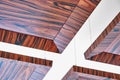 Wooden ceiling panels. Rosewood fineline veneer ceiling panels in the modern office Royalty Free Stock Photo