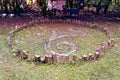 Wooden Celtic triskelion sign standing in a green grassy meadow in Switzerland