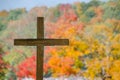 Wooden cemetery cross and fall color trees Royalty Free Stock Photo