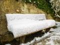 Wooden chair covered in snow in a mirabell garden.Austria Salzburg winter.