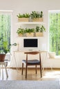 Wooden chair at desk with desktop computer in bright workspace i Royalty Free Stock Photo