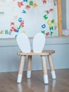 wooden chair for kids with a white board and magnets in the background Royalty Free Stock Photo