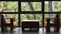 Wooden chair in living room with modern glass window having green natural forest view for nature style lifestyle