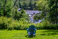 Wooden chair in the park facing the lake Royalty Free Stock Photo