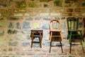 Wooden chair placed in front of a brick wall Royalty Free Stock Photo