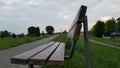 wooden chair beside the rhine river, peaceful and quiet area beside Cologne city, Germany.