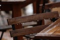 Wooden chair and table from a cafe in the rain. Wet urban furniture.