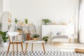 Wooden chair and table with open book placed on carpet in real p Royalty Free Stock Photo