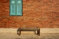 Wooden chair with vintage red brick wall and blue window. Vintage background Royalty Free Stock Photo