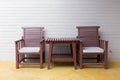 Wooden chair on yellow cement floor with mortar wall Royalty Free Stock Photo