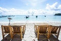 Wooden chairs on the beach at seaside for relaxation Royalty Free Stock Photo