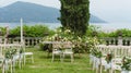 Wooden chairs decorated with flowers for an outdoor wedding event Royalty Free Stock Photo