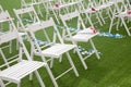 Wooden chairs for guests of the celebration. Wedding ceremony in the garden. Royalty Free Stock Photo