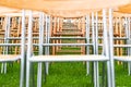 Wooden chairs outside in the park in the rain. Empty auditorium, grass and water drops Royalty Free Stock Photo