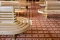 Wooden chairs for passengers, waiting for train in the station. With beautiful tile pattern