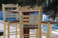 Wooden chairs by the pool Royalty Free Stock Photo