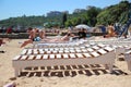 Wooden chairs and resting people lying on them.