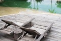 Wooden chairs side the pool. Royalty Free Stock Photo