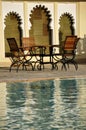 Wooden chairs by a swimming pool Royalty Free Stock Photo