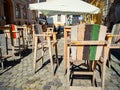 Wooden chairs and table on a cobbled street. Outdoor restaurant terrace cafe in the center of Timisoara city, Romania Royalty Free Stock Photo