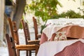 Wooden chairs and table with glasses at a Greek tavern - restaurant in Plaka, Athens Royalty Free Stock Photo