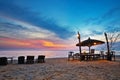 Wooden chairs and umbrellas on sand beach Royalty Free Stock Photo