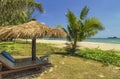 Wooden chairs and umbrellas on white sand beach Royalty Free Stock Photo