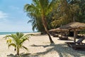 Wooden chairs and umbrellas on white sand beach Royalty Free Stock Photo