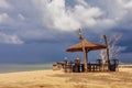 Wooden chairs and umbrellas on white sand beach Royalty Free Stock Photo