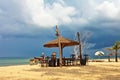 Wooden chairs and umbrellas on white sand beach Royalty Free Stock Photo