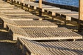 Wooden chaise lounge on the beach on a sunny day. Royalty Free Stock Photo